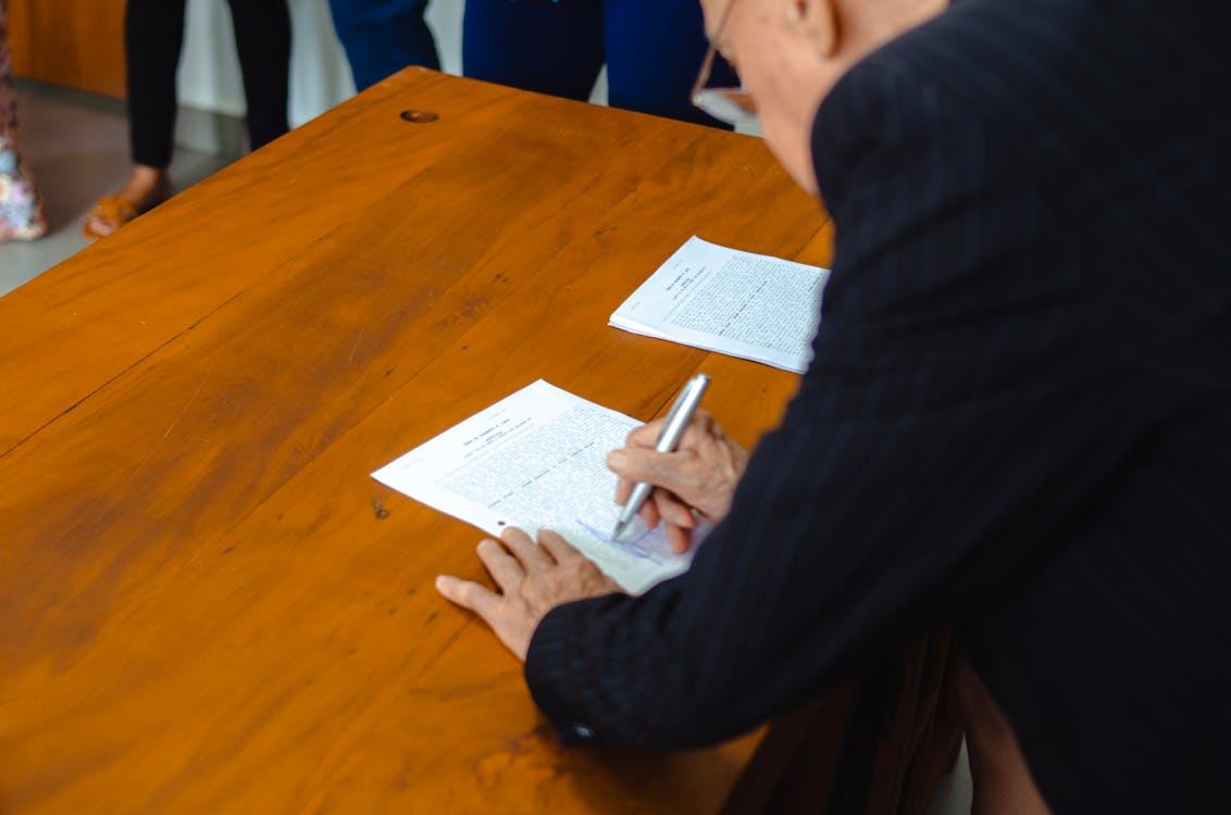 free-photo-of-businessman-signing-documents-in-office-setting
